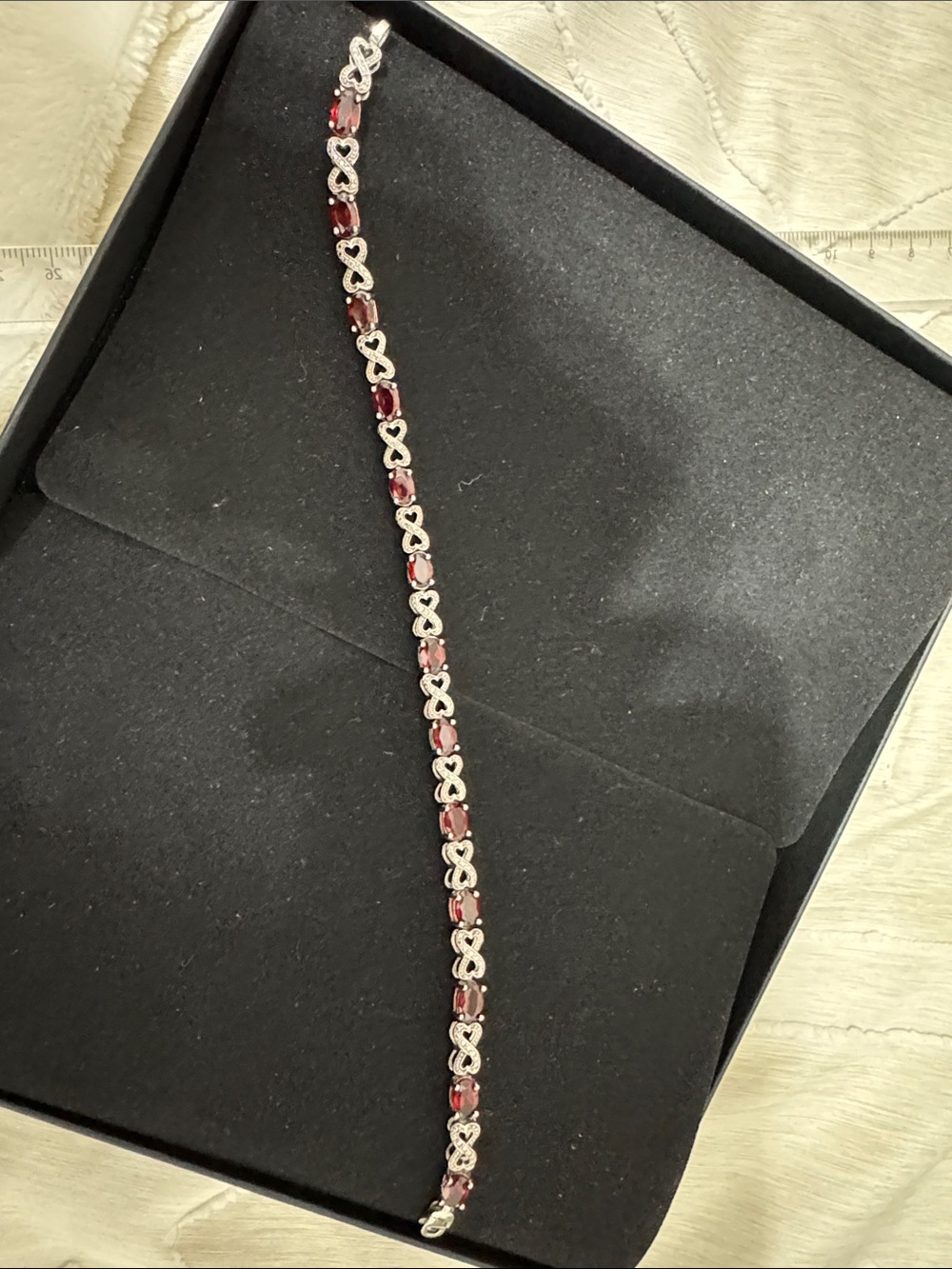 A Classy Chic Boutique Silver Infinity Bracelet with Red Stones